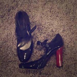 Adorable patent leather Mary Janes with red heel.